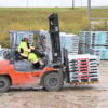 S245 S876 Man driving a forklift wearing Work King fleece lined jacket and insulated safety overall